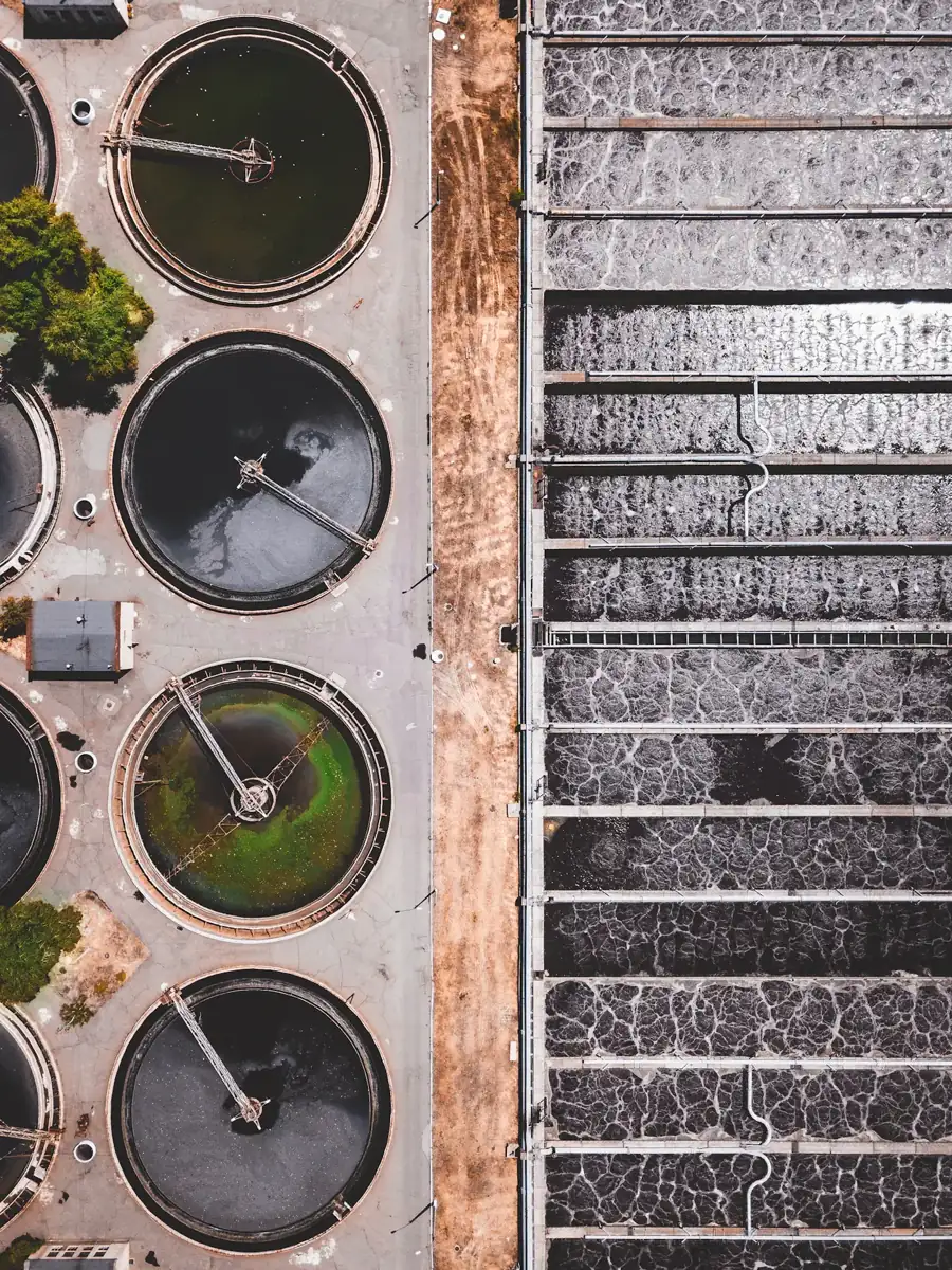 Aerial view of circular water treatment tanks and settling basins